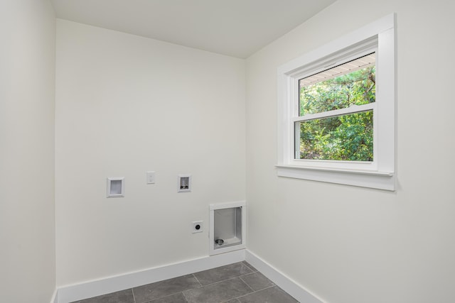 washroom featuring electric dryer hookup, baseboards, laundry area, hookup for a washing machine, and dark tile patterned flooring
