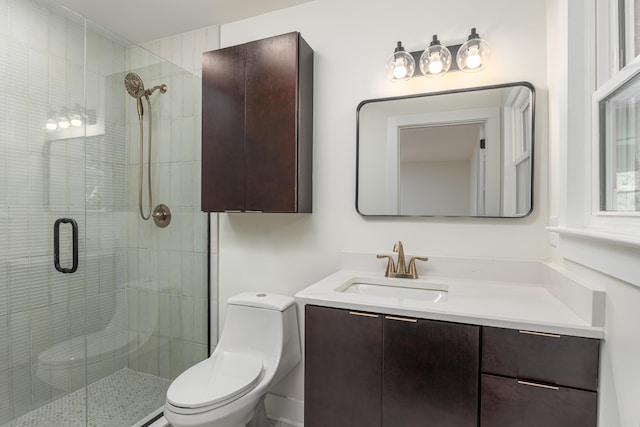 full bathroom featuring toilet, a shower stall, and vanity