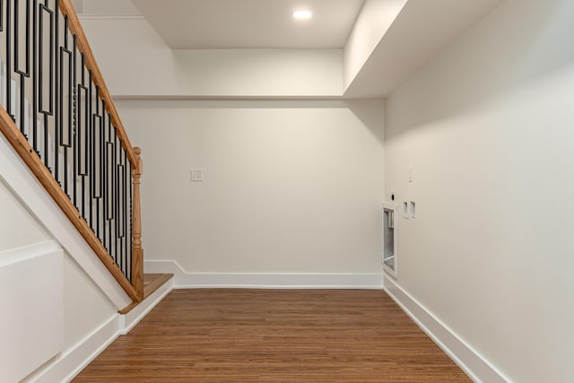 washroom with wood finished floors, hookup for an electric dryer, baseboards, and recessed lighting