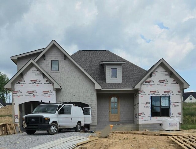 unfinished property featuring roof with shingles