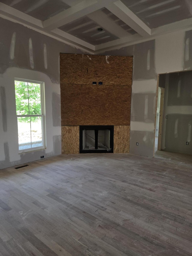 10597 Brownspring Dr Unit 115, Apison, TN 37302 - unfurnished living room featuring beam ceiling, wood finished floors, and a premium fireplace