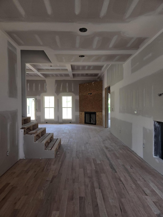 10597 Brownspring Dr Unit 115, Apison, TN 37302 - unfurnished living room featuring wood finished floors, coffered ceiling, beamed ceiling, and a large fireplace