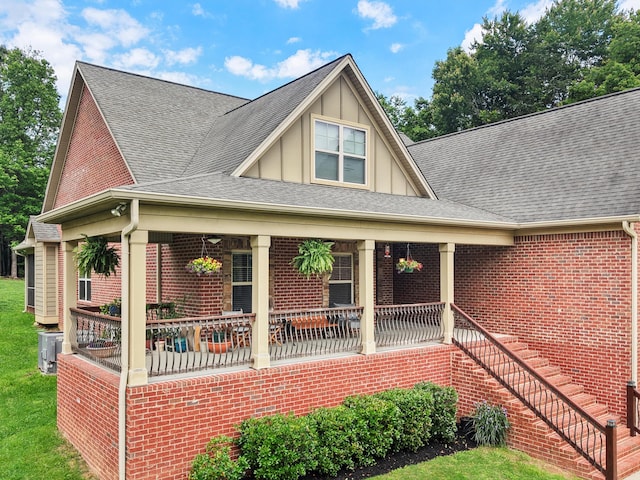 7415 Island Manor Dr, Harrison, TN 37341 - view of front of house with a porch, board and batten siding, and a shingled roof