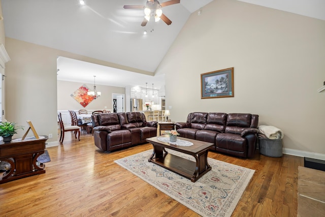 7415 Island Manor Dr, Harrison, TN 37341 - living room featuring a chandelier, high vaulted ceiling, ceiling fan, light wood-type flooring, and baseboards