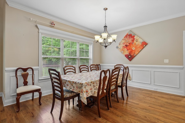 7415 Island Manor Dr, Harrison, TN 37341 - dining room featuring a chandelier, crown molding, wainscoting, wood finished floors, and a decorative wall