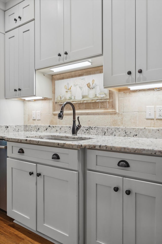 7415 Island Manor Dr, Harrison, TN 37341 - kitchen featuring a sink, dark wood-style floors, tasteful backsplash, white cabinets, and light stone countertops