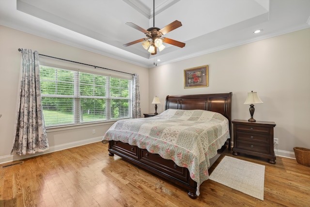 7415 Island Manor Dr, Harrison, TN 37341 - bedroom with a tray ceiling, ornamental molding, baseboards, wood finished floors, and recessed lighting