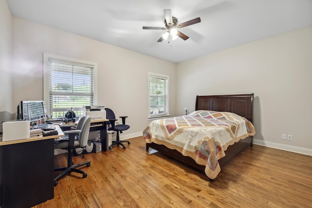 7415 Island Manor Dr, Harrison, TN 37341 - bedroom featuring light wood-style floors, baseboards, a desk, and a ceiling fan