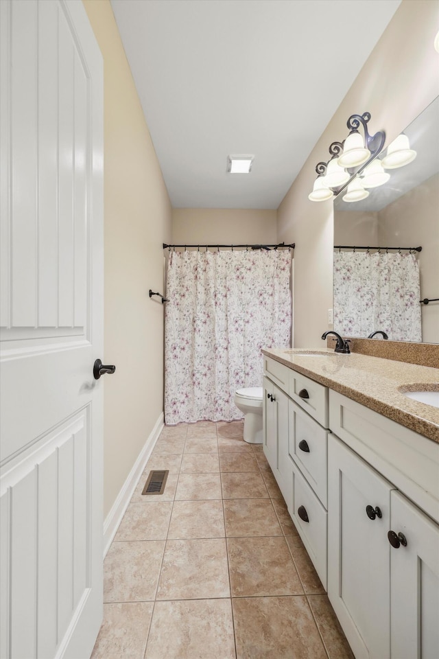 7415 Island Manor Dr, Harrison, TN 37341 - bathroom with double vanity, toilet, tile patterned flooring, and baseboards