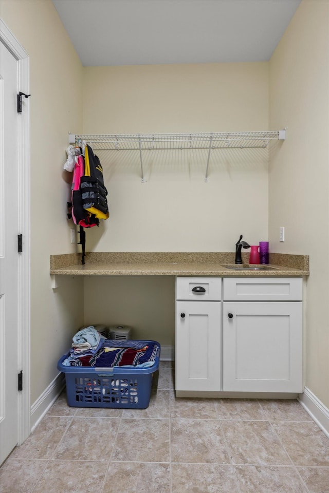 7415 Island Manor Dr, Harrison, TN 37341 - laundry room featuring a sink, baseboards, and light tile patterned flooring