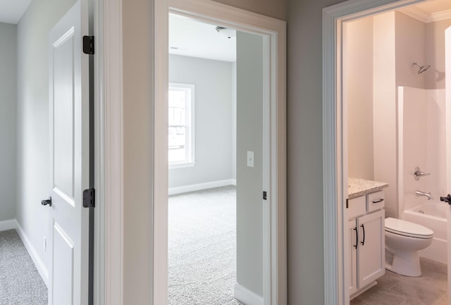 full bath with vanity, bathtub / shower combination, baseboards, and toilet