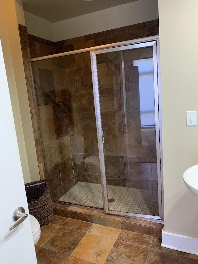 129 Walnut St Unit 322, Chattanooga, TN 37403 - bathroom featuring a stall shower, toilet, and stone tile floors