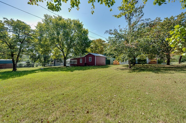 view of yard with an outdoor structure and fence