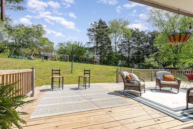 wooden deck with a lawn, fence, and a playground