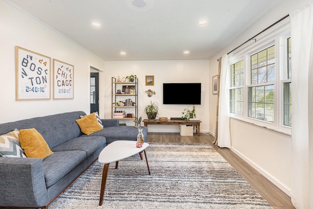 living room with recessed lighting, baseboards, and wood finished floors