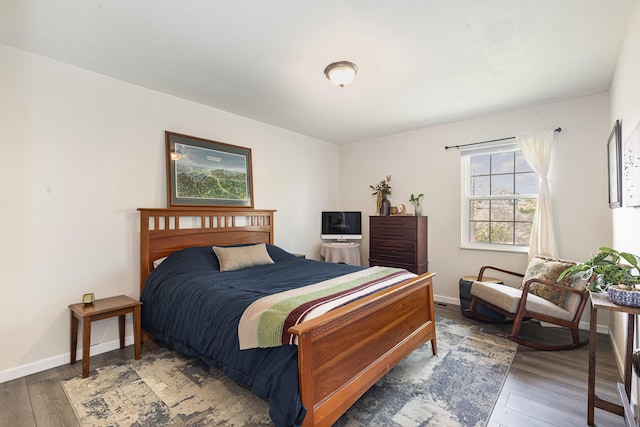 bedroom with wood-type flooring and baseboards