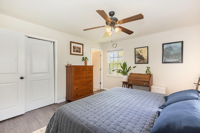bedroom with baseboards, a ceiling fan, and wood finished floors