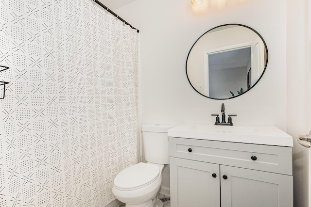 full bathroom with vanity, toilet, and curtained shower