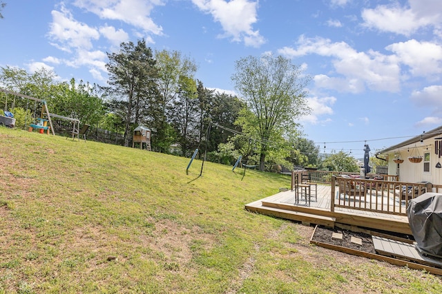 view of yard with a playground and a wooden deck