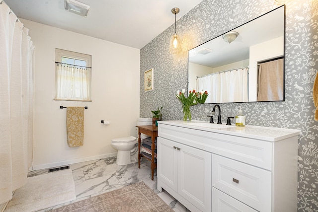 bathroom with toilet, visible vents, marble finish floor, and vanity