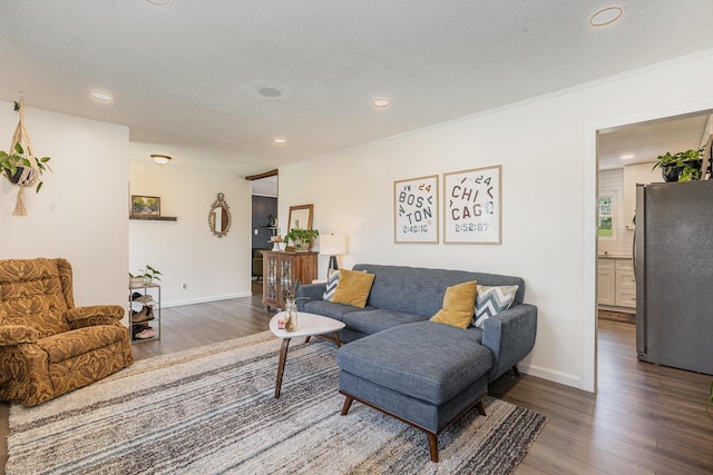 living room featuring baseboards, recessed lighting, and wood finished floors