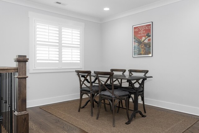 dining space with wood finished floors, baseboards, crown molding, and recessed lighting