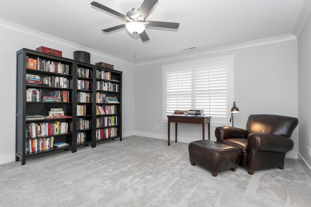 living area with a ceiling fan, carpet flooring, ornamental molding, and baseboards