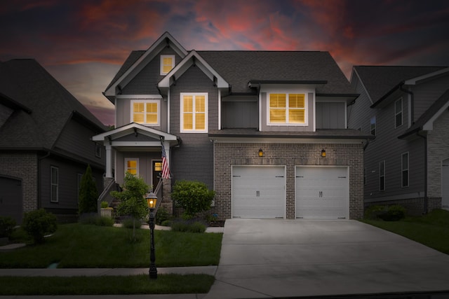 craftsman inspired home with driveway, a garage, brick siding, a front lawn, and board and batten siding