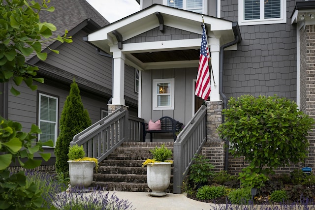 entrance to property with covered porch and board and batten siding