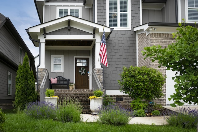 entrance to property featuring board and batten siding and covered porch