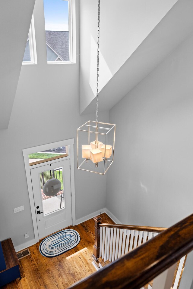 9876 Trestle Cir, Ooltewah, TN 37363 - foyer entrance featuring wood finished floors, visible vents, an inviting chandelier, and a healthy amount of sunlight