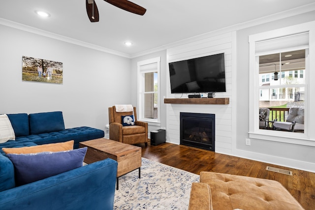 9876 Trestle Cir, Ooltewah, TN 37363 - living area with crown molding, wood finished floors, ceiling fan, a large fireplace, and visible vents