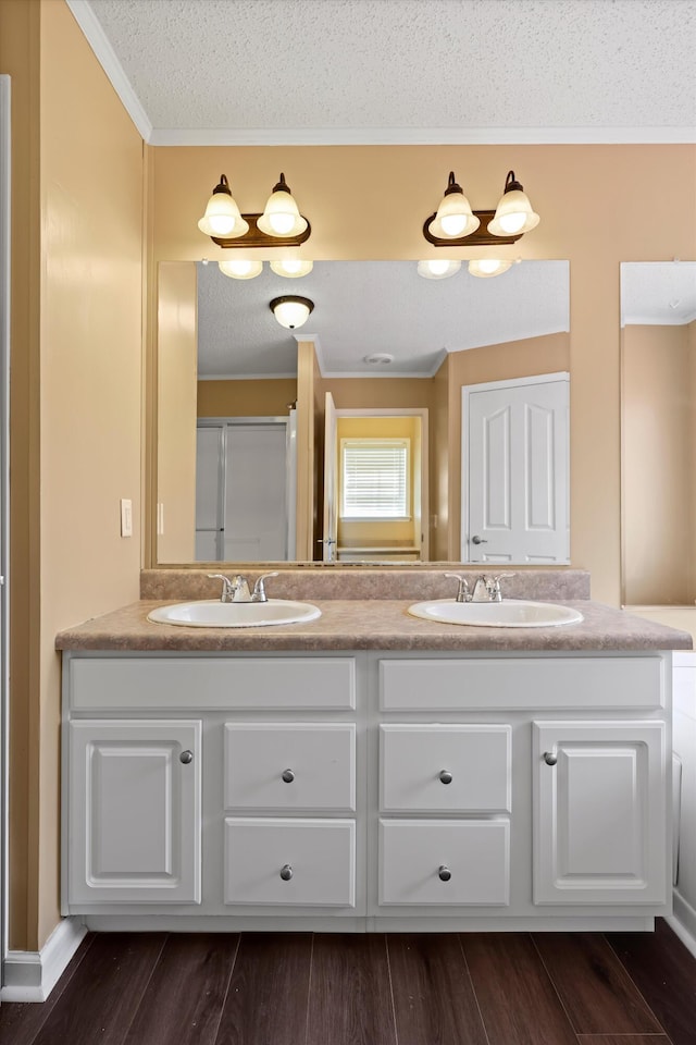 325 Pocket Rd, Whitwell, TN 37397 - bathroom with double vanity, a sink, a textured ceiling, and ornamental molding
