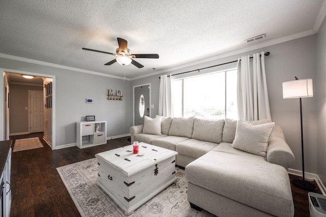 living area with visible vents, crown molding, a ceiling fan, and wood finished floors