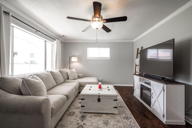 living room featuring dark wood-style floors, a textured ceiling, ornamental molding, and ceiling fan