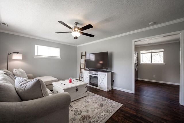 living room with a ceiling fan, a textured ceiling, ornamental molding, and dark wood finished floors