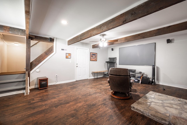 sitting room with baseboards, ceiling fan, beamed ceiling, wood finished floors, and stairs