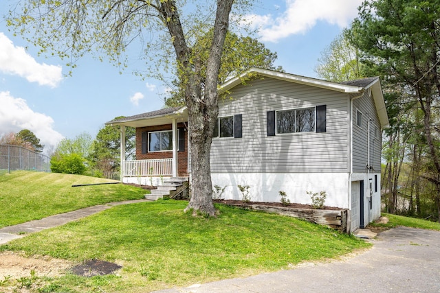 view of front of house with a front yard and covered porch