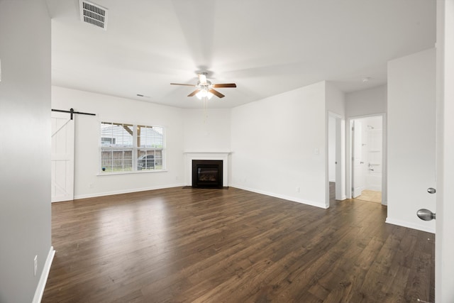 127 Huntley Meadows Dr, Rossville, GA 30741 - unfurnished living room featuring baseboards, a barn door, visible vents, dark wood finished floors, and ceiling fan