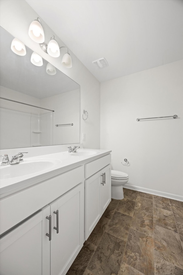 127 Huntley Meadows Dr, Rossville, GA 30741 - bathroom with a sink, toilet, double vanity, and stone finish floor