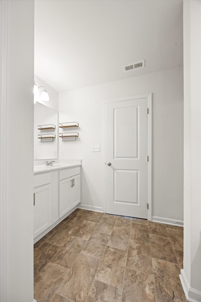 127 Huntley Meadows Dr, Rossville, GA 30741 - bathroom featuring stone finish flooring, vanity, baseboards, and visible vents