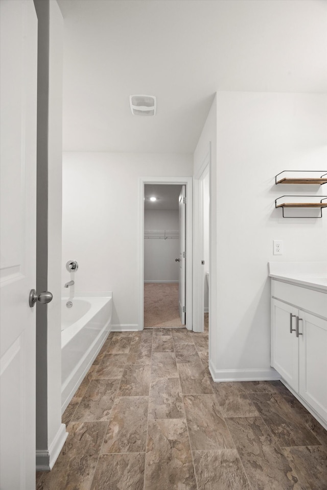127 Huntley Meadows Dr, Rossville, GA 30741 - bathroom featuring baseboards, stone finish floor, vanity, and a garden tub