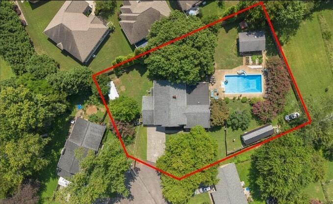 aerial view of property and surrounding area with property parcel outlined and a pool area