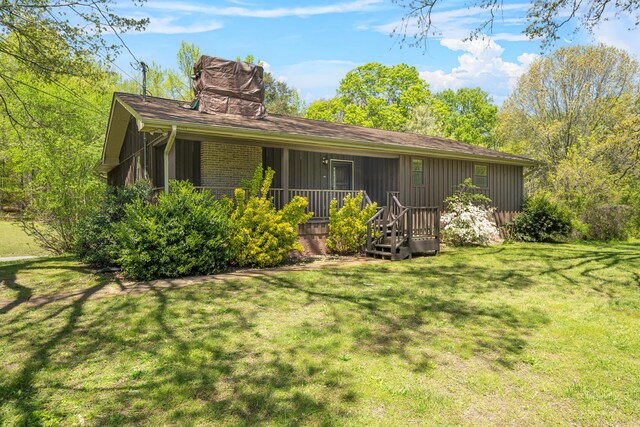 401 Laymons Rd, Hixson, TN 37343 - rear view of house featuring a yard, a porch, and a chimney