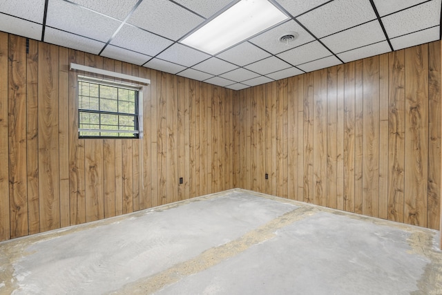 401 Laymons Rd, Hixson, TN 37343 - empty room with wooden walls, visible vents, a paneled ceiling, and unfinished concrete floors