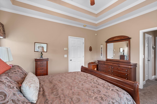 carpeted bedroom featuring crown molding, ceiling fan, and a tray ceiling