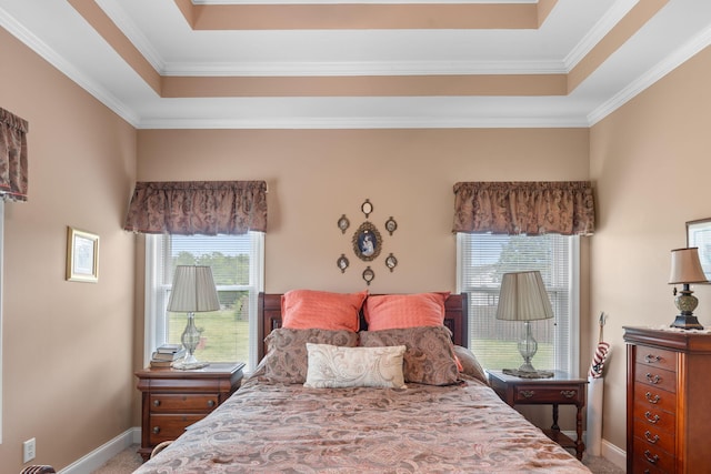 bedroom with crown molding, a raised ceiling, baseboards, and carpet flooring