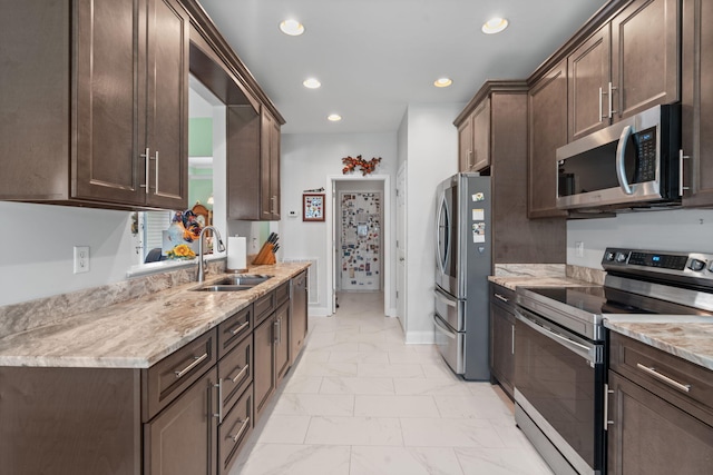 kitchen with a sink, appliances with stainless steel finishes, marble finish floor, and dark brown cabinets