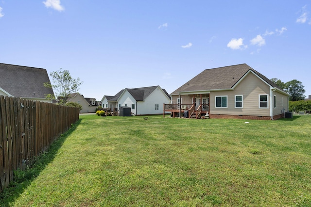 exterior space featuring a deck, fence, and cooling unit