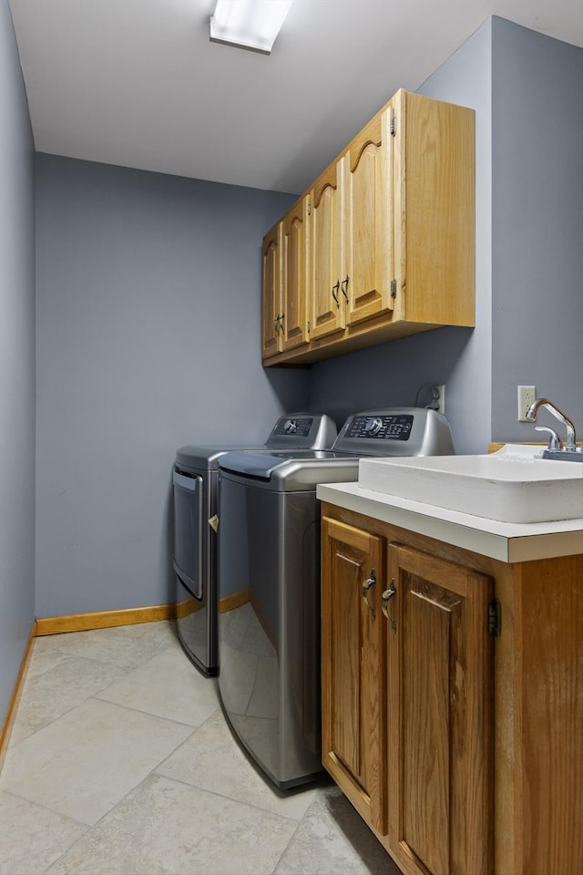 6500 Waconda Point Rd, Harrison, TN 37341 - washroom with washing machine and dryer, baseboards, light tile patterned floors, and cabinet space